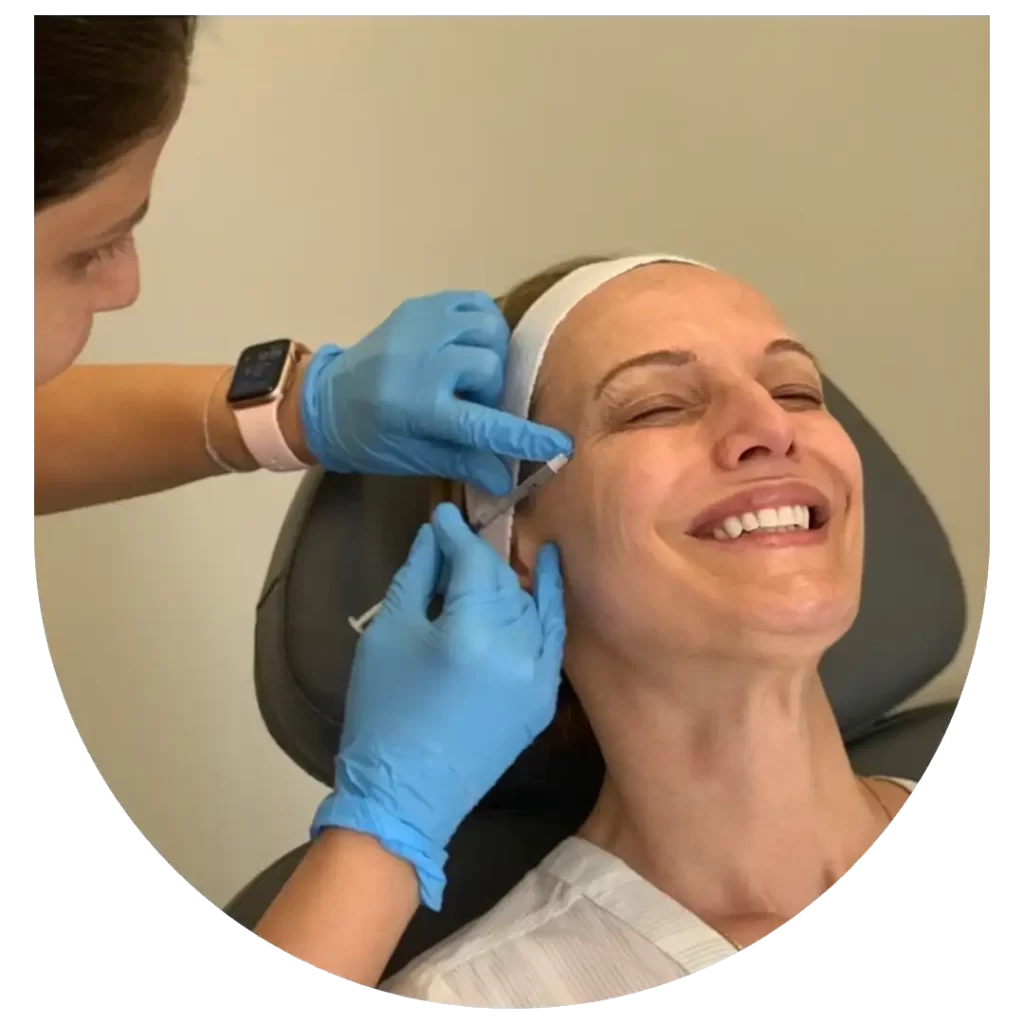 An Image showing Dr. Lal Injecting botox on patient's face to eliminate lateral canthal lines at Upper West Side location
