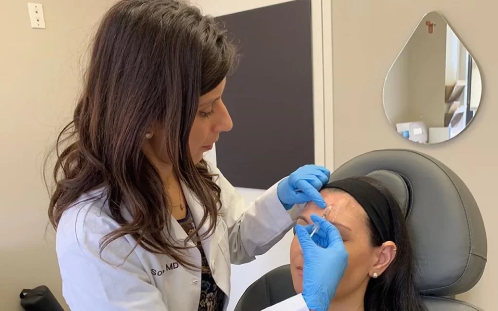 A woman receiving Botox treatment for a forehead lines from a Dr. Sonali Lal