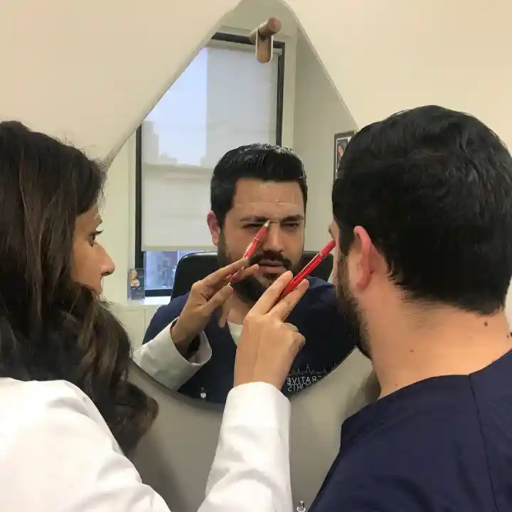 Dr. Sonali preparing a patient for his Botox procedure and shows him where the injections will be placed