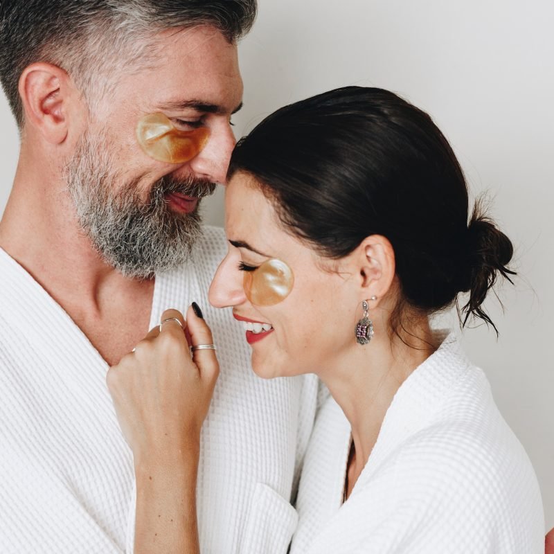 Couple relaxing with golden eye mask treatment